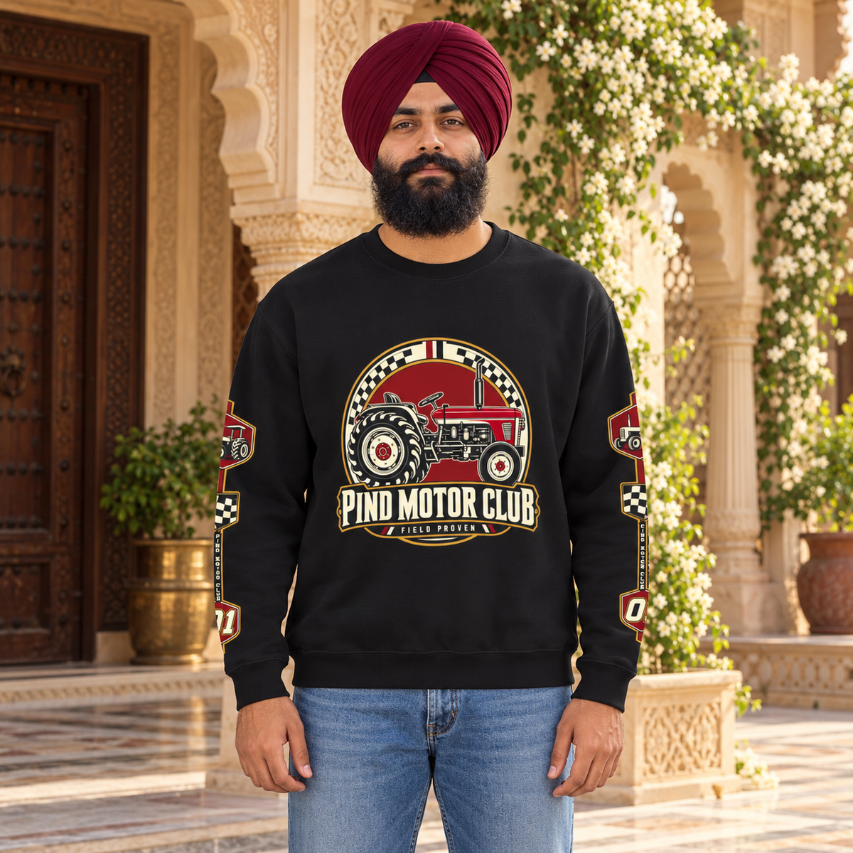 Pind Motor Club black tractor sweatshirt with front and sleeve prints, Sikh model in premium Punjabi haveli