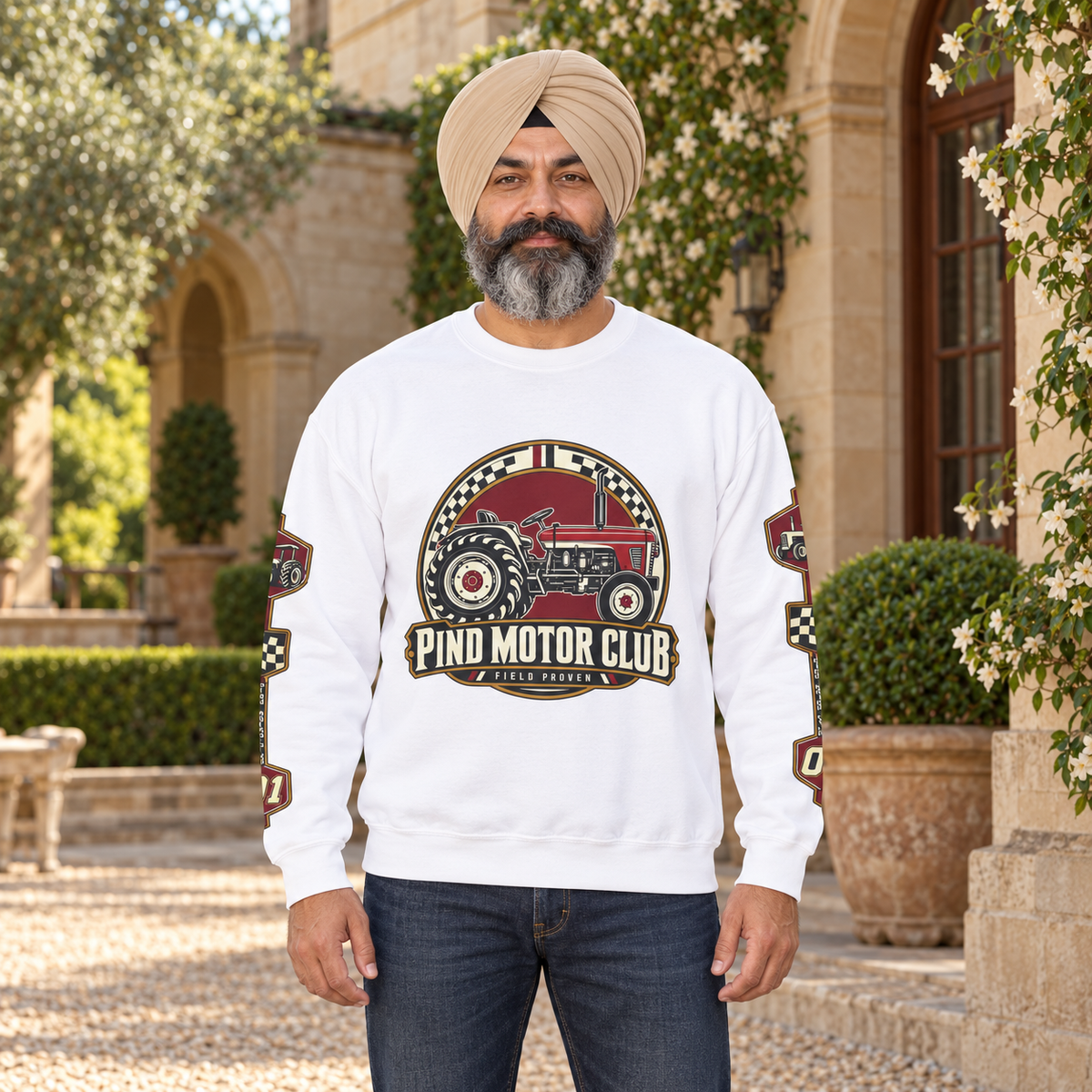 Pind Motor Club white sweatshirt, centered tractor and sleeve prints, Sikh model in country estate courtyard